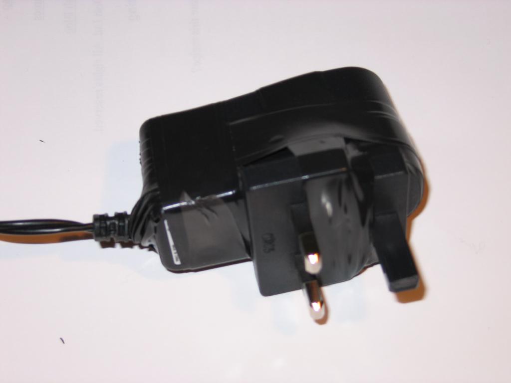 A photo of the NSLU2 power supply re-assembled, and held together with black electrical tape